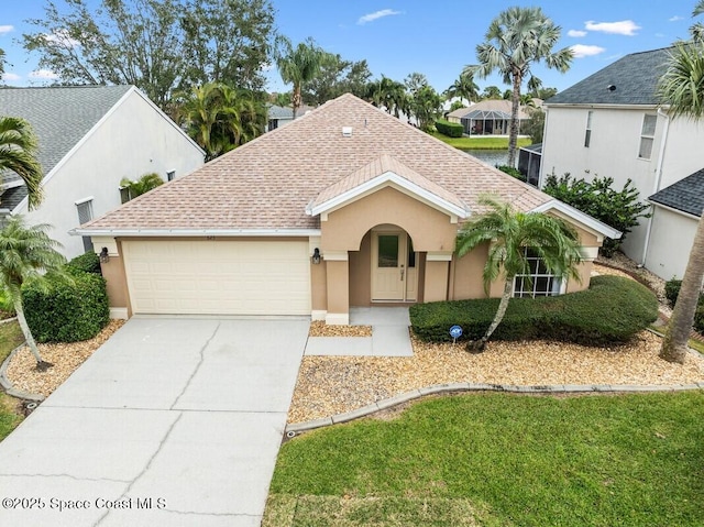 view of front of property featuring a garage and a front yard