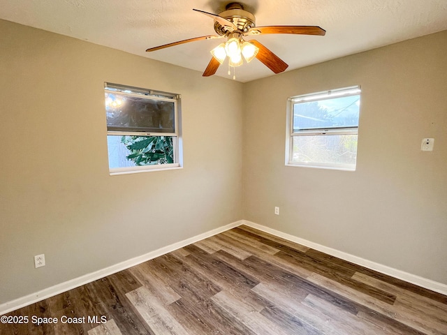 spare room with hardwood / wood-style floors, a textured ceiling, and ceiling fan