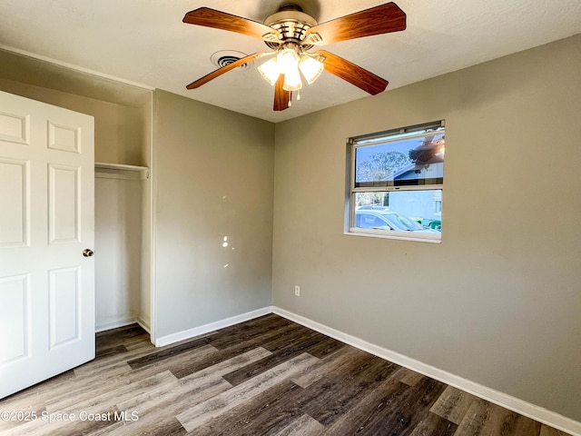 unfurnished bedroom with wood-type flooring, a closet, and ceiling fan