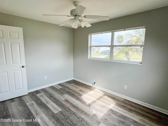 unfurnished room featuring ceiling fan and dark hardwood / wood-style flooring