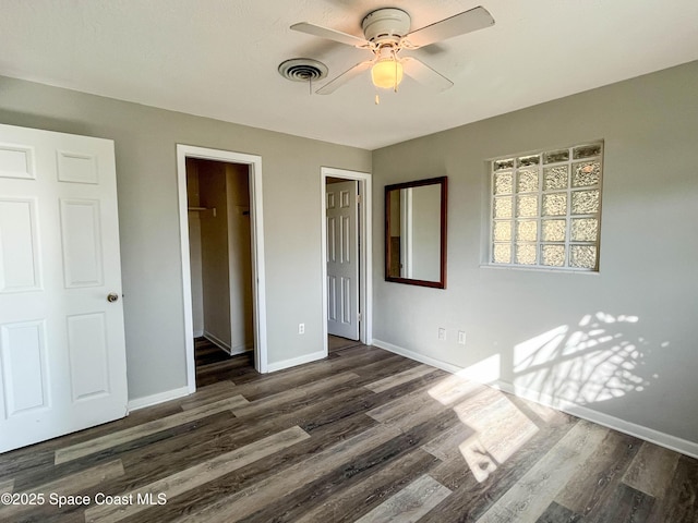 unfurnished bedroom with dark wood-type flooring and ceiling fan