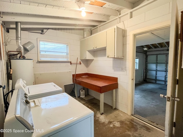 laundry room with cabinets, washing machine and dryer, and gas water heater