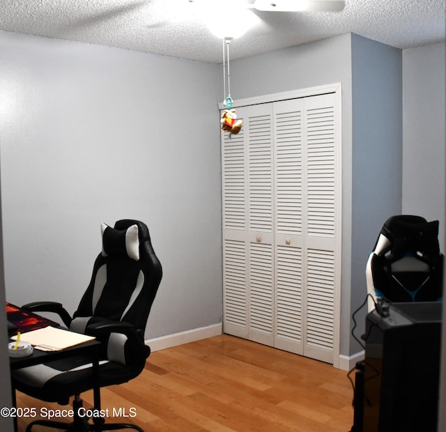 office space with hardwood / wood-style floors and a textured ceiling