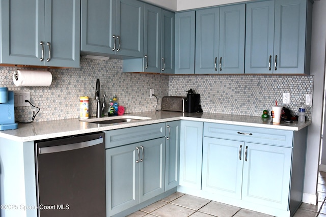 kitchen with tasteful backsplash, dishwashing machine, sink, and light tile patterned floors