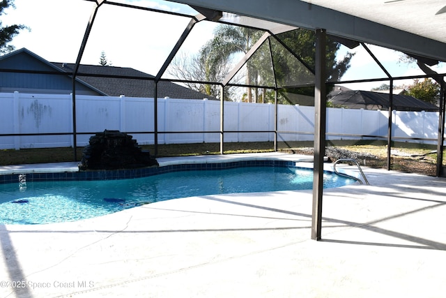 view of pool featuring glass enclosure and a patio area