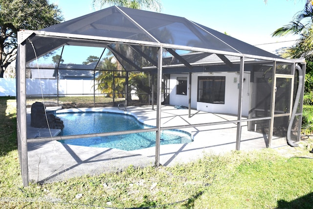 view of swimming pool with a lanai and a patio area