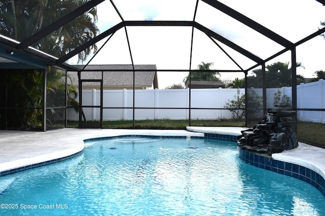 view of swimming pool with a patio area and glass enclosure