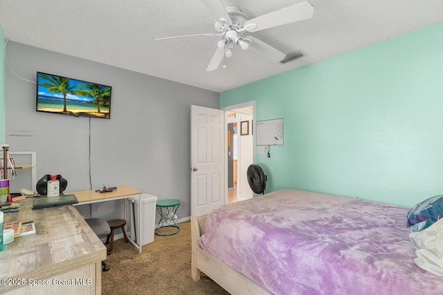 carpeted bedroom with ceiling fan and a textured ceiling