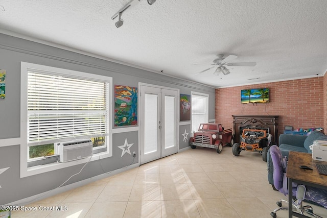 living room featuring french doors, light tile patterned floors, a textured ceiling, and a wealth of natural light