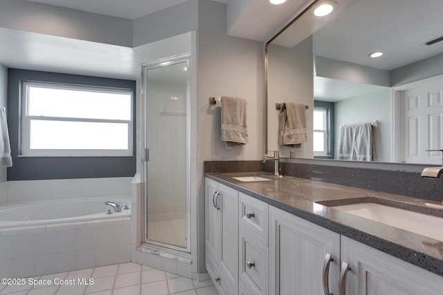 bathroom with shower with separate bathtub, tile patterned floors, and vanity