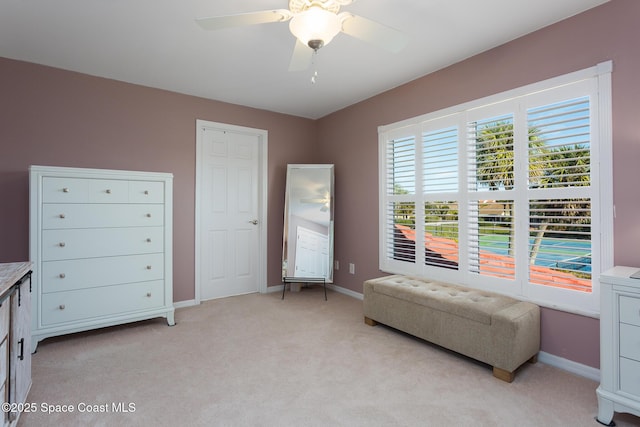 sitting room with light colored carpet and ceiling fan