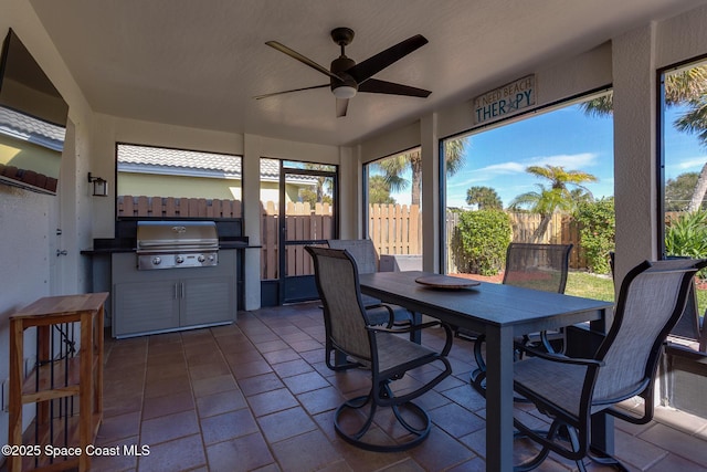 sunroom featuring ceiling fan