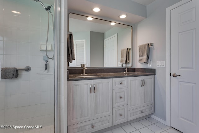 bathroom with vanity, tile patterned floors, and a shower with shower door