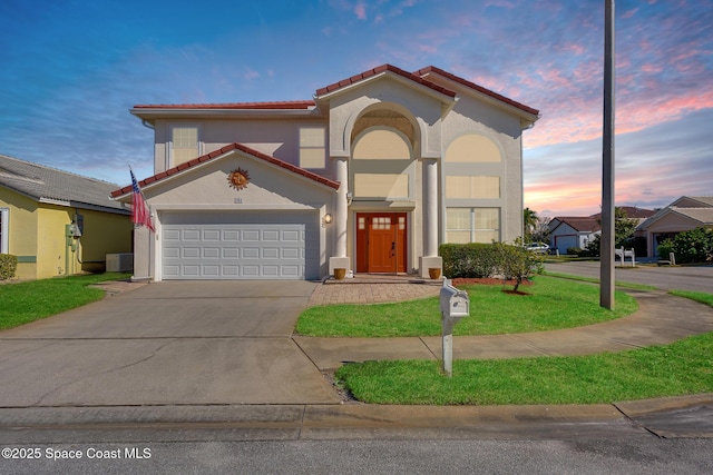 mediterranean / spanish-style home with cooling unit and a lawn