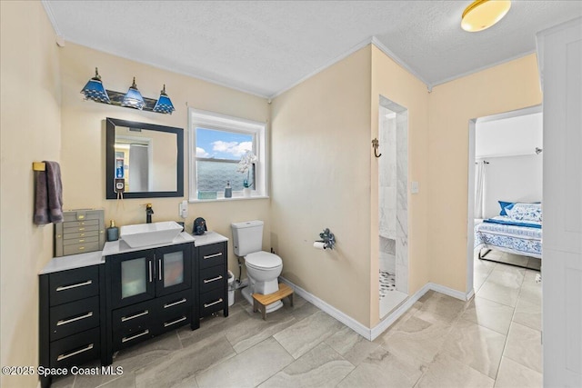 bathroom with ornamental molding, vanity, walk in shower, toilet, and a textured ceiling