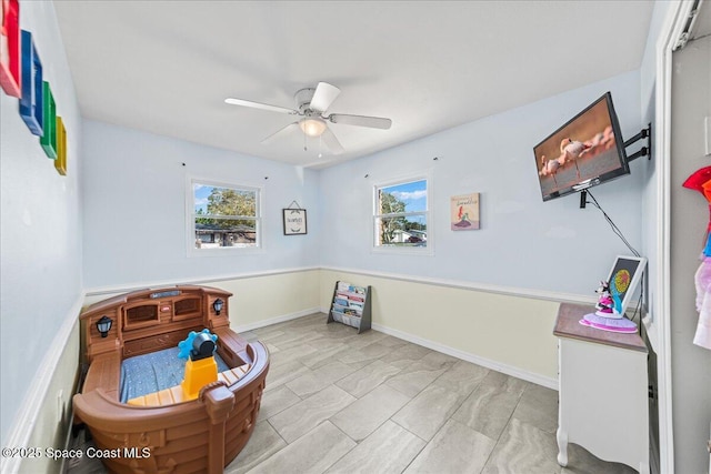 sitting room with ceiling fan and a wealth of natural light