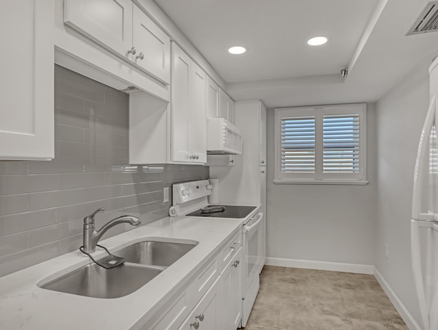 kitchen with sink, backsplash, white cabinets, light stone counters, and white appliances