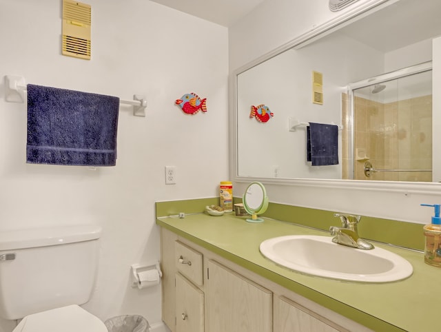 bathroom with vanity, an enclosed shower, and toilet