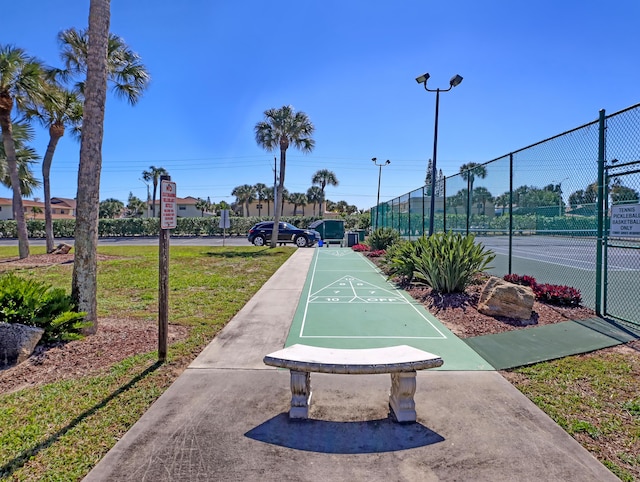 view of home's community with tennis court