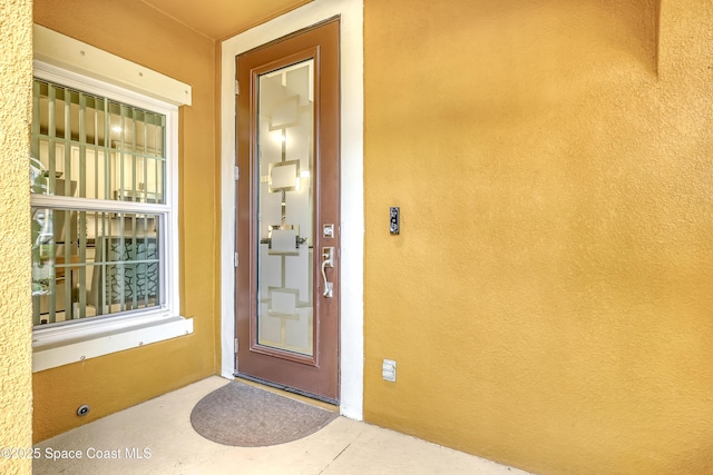 doorway to property with stucco siding