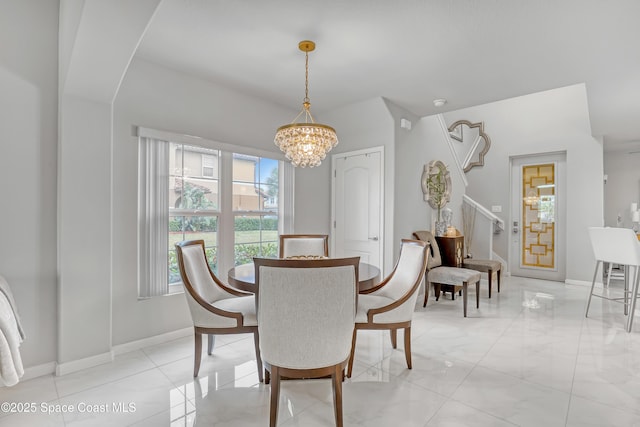 dining space featuring a notable chandelier and baseboards