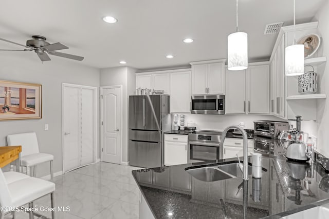 kitchen featuring visible vents, marble finish floor, stainless steel appliances, a ceiling fan, and open shelves