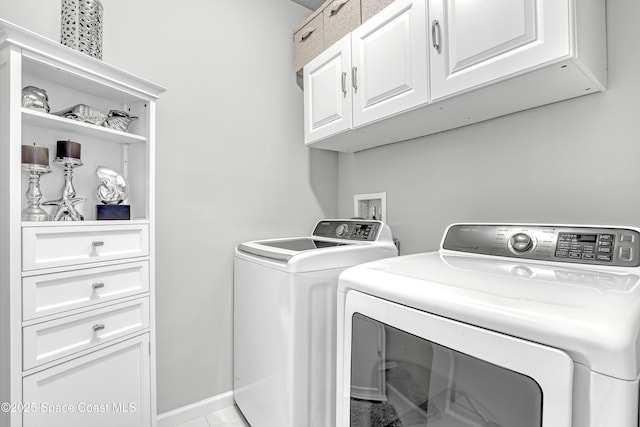 washroom with cabinet space and separate washer and dryer