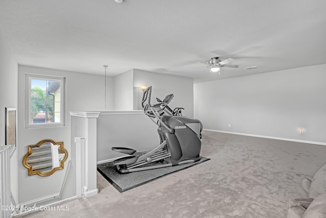 workout room with a ceiling fan, visible vents, carpet, and baseboards