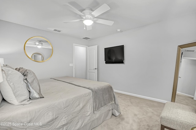 bedroom with baseboards, visible vents, and light carpet