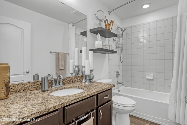 bathroom with shower / bathtub combination with curtain, visible vents, toilet, wood finished floors, and vanity