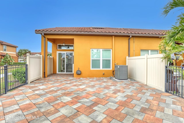 view of patio / terrace with central AC unit and fence