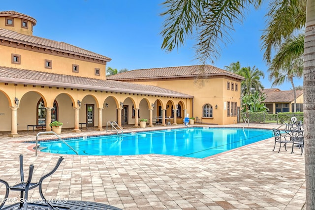 pool featuring a patio area and fence