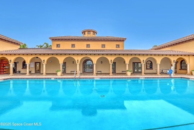 community pool featuring a patio area and french doors