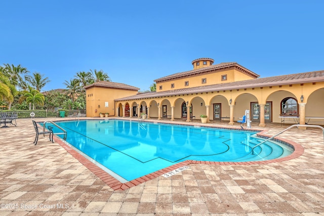 community pool featuring a patio area and fence