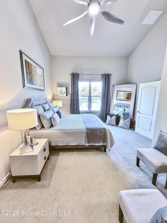 bedroom featuring visible vents, lofted ceiling, ceiling fan, and carpet flooring