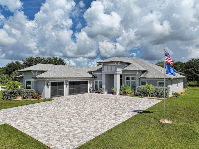 view of front of home with a garage and a front yard