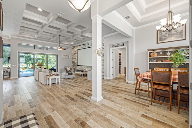 interior space with decorative columns, coffered ceiling, ceiling fan with notable chandelier, and light wood-type flooring