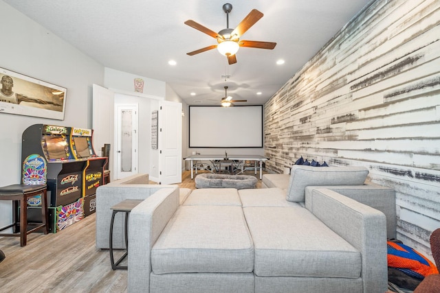 cinema with hardwood / wood-style floors and ceiling fan