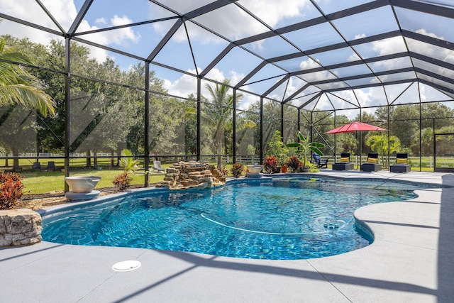 view of swimming pool with a patio area and glass enclosure