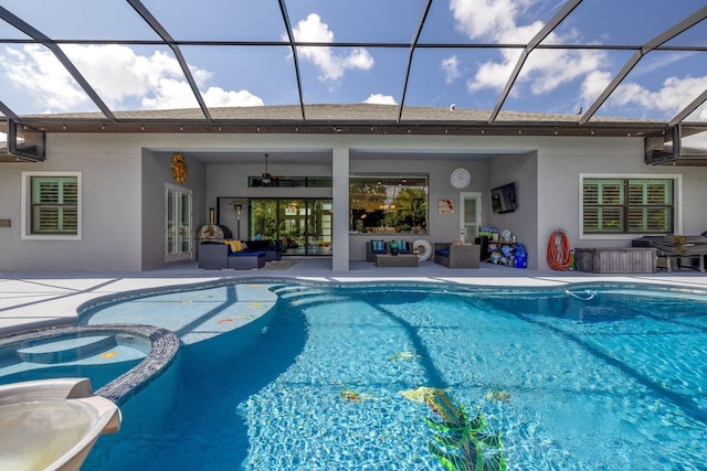 view of pool featuring ceiling fan, a patio, outdoor lounge area, and glass enclosure