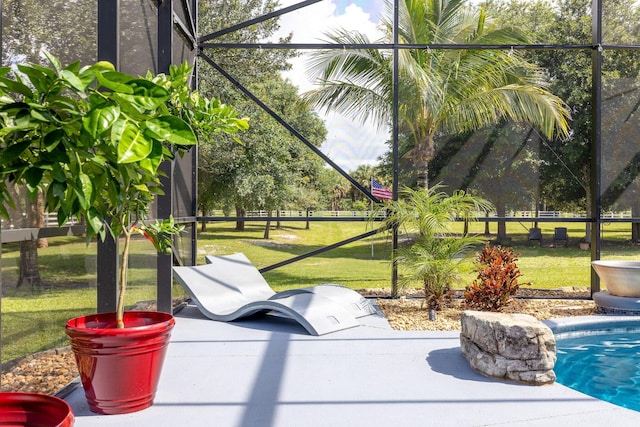 view of property's community featuring a yard, a swimming pool, and a patio