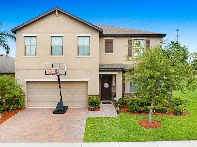 view of front of property featuring a garage and a front lawn