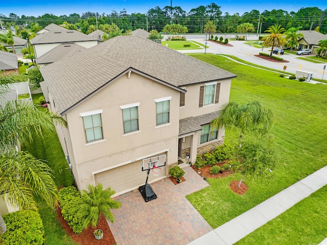 view of front of property featuring a garage and a front lawn