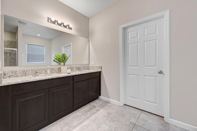 bathroom with vanity and an enclosed shower