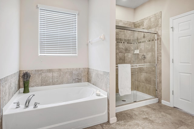 bathroom with tile patterned floors and independent shower and bath