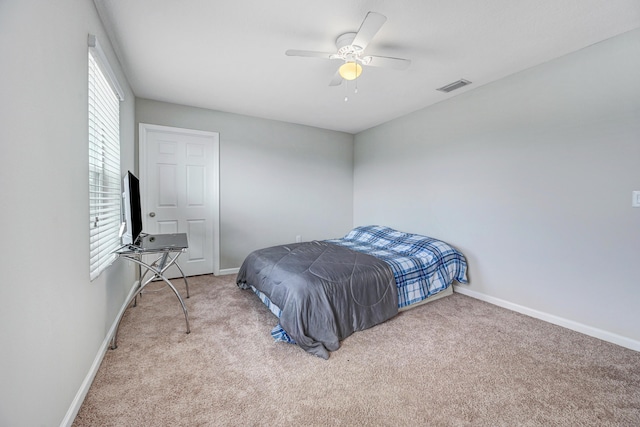 bedroom featuring light colored carpet and ceiling fan