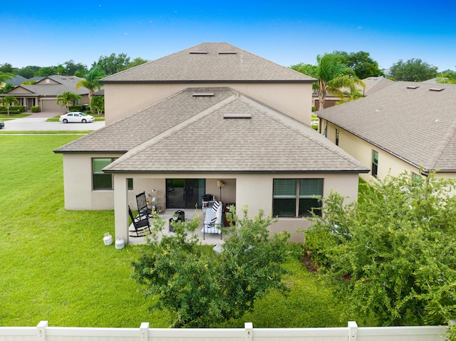 back of house featuring a patio area and a lawn