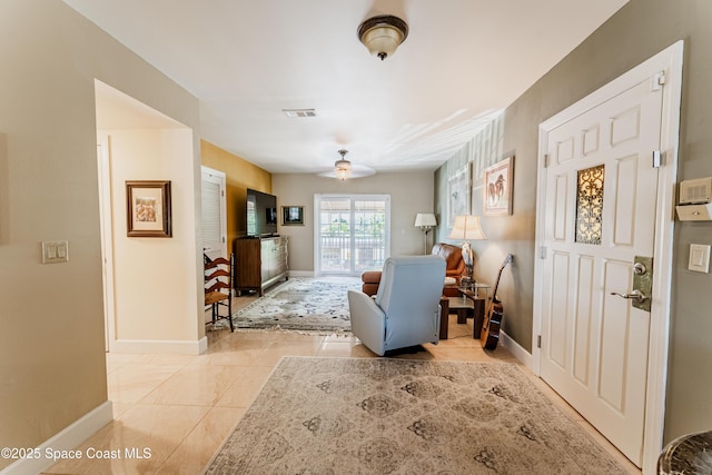 sitting room featuring light tile patterned floors and ceiling fan