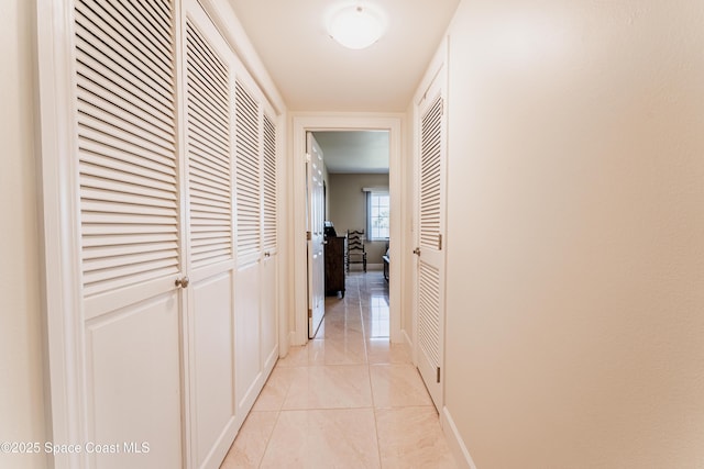 corridor featuring light tile patterned floors