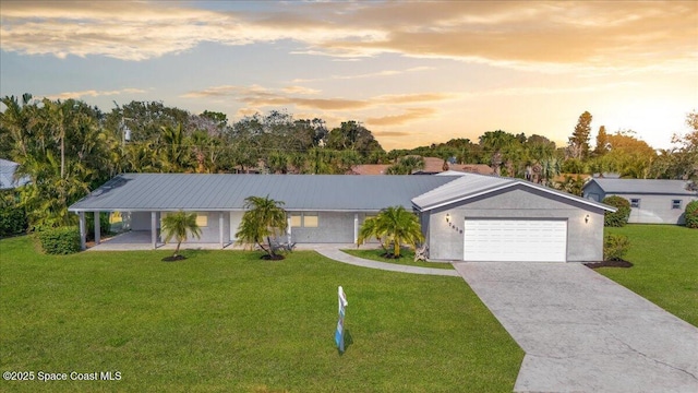 ranch-style house with a garage and a yard